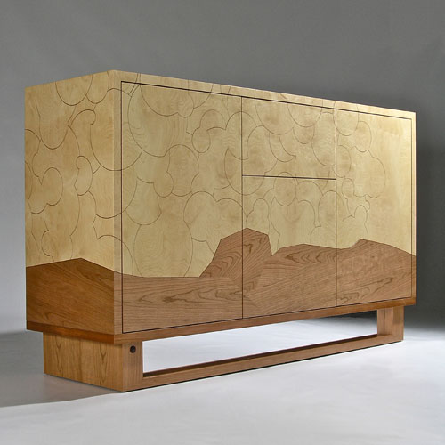 Storage cabinet featuring marquetry and engraved lines to detail a cloud pattern